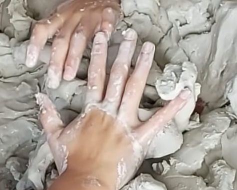 Child’s hands exploring clay during Clay Field Therapy in Liverpool