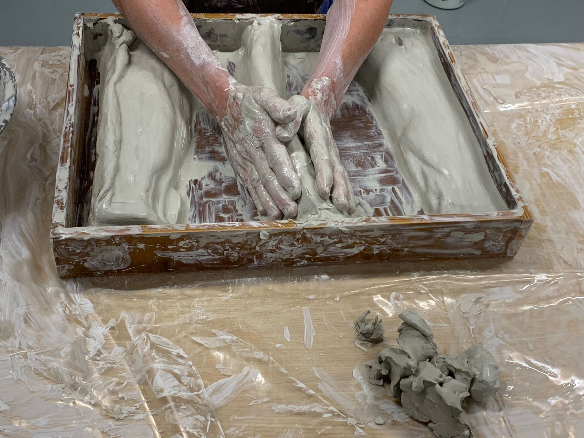 Hands pressing into clay during Clay Field Therapy in Liverpool